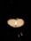 A mystical candle lit in a dark room, symbolizing love and magic.