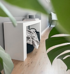 A sleek console table finished by hand with Egyptian sand texture, set against a beige background.