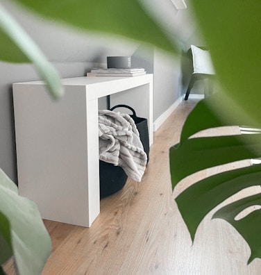 Modern decorative objects arranged on a sleek console table against a soft gray wall.