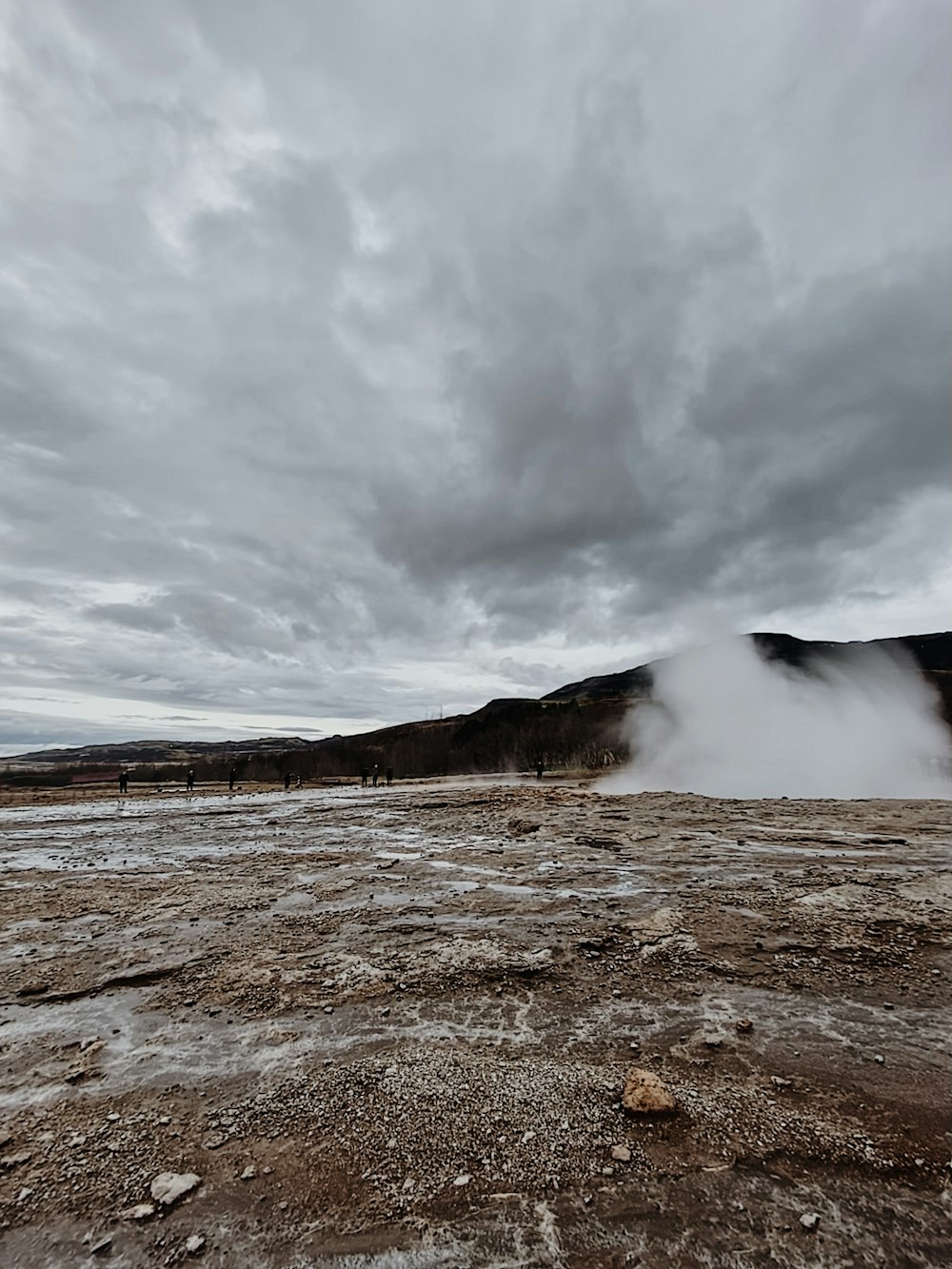 a large body of water with steam coming out of it