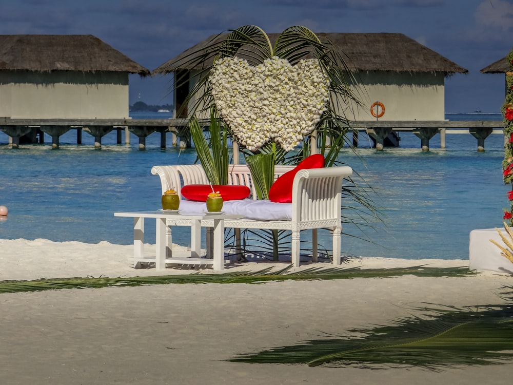 a couple of chairs and a table on a beach