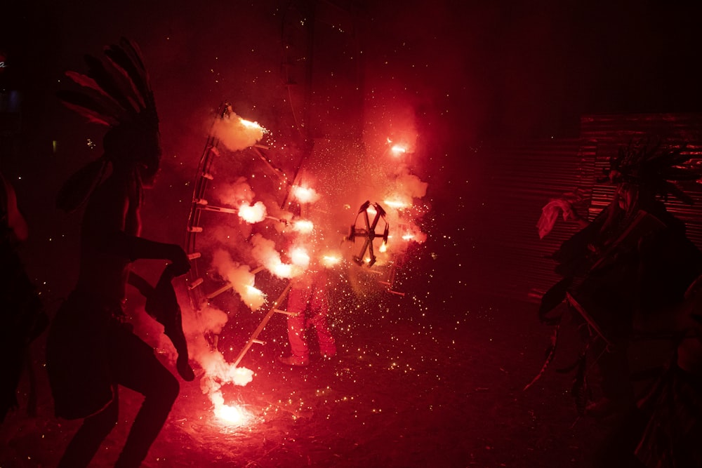 a group of people standing around a firework display