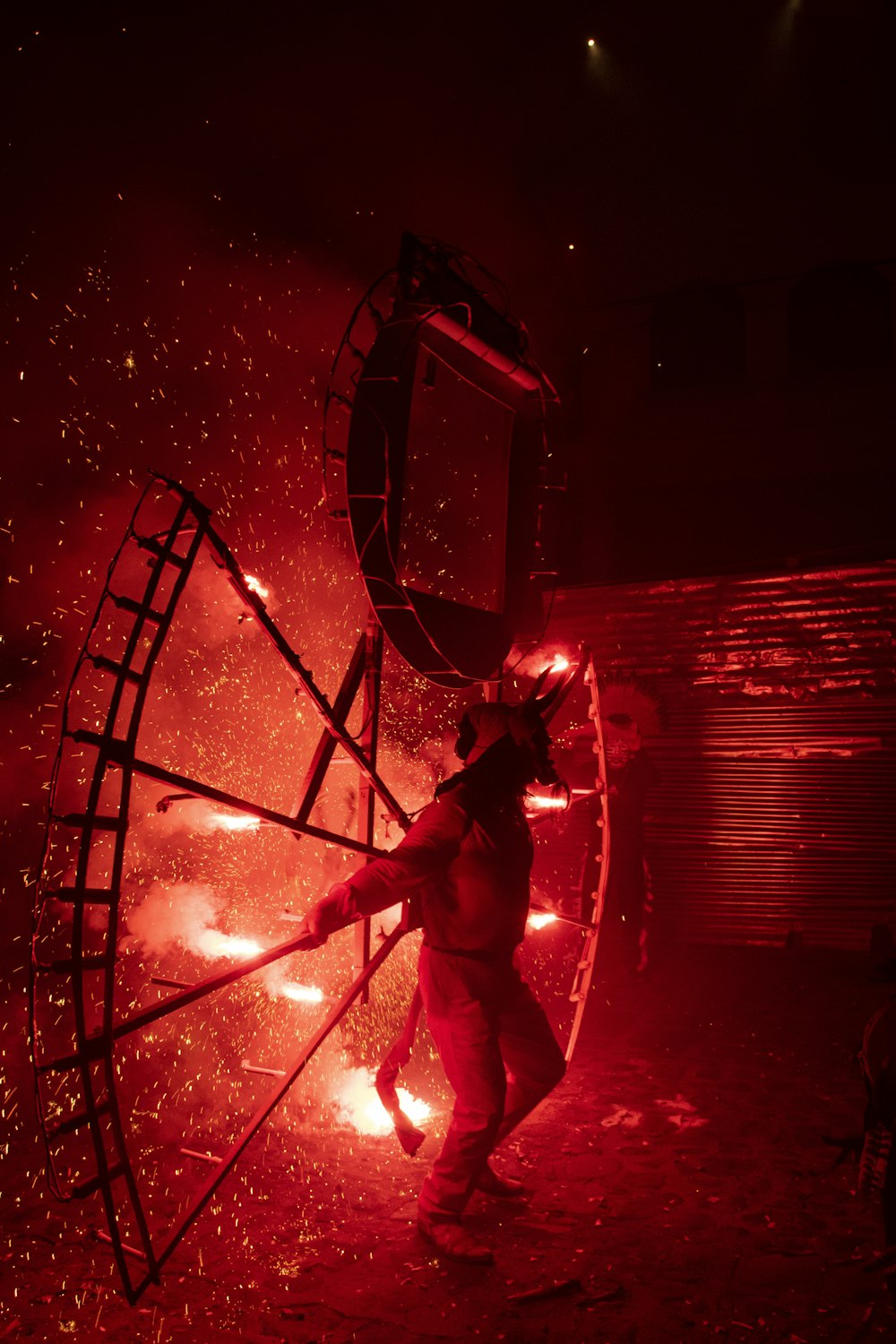 a man standing in front of a red light