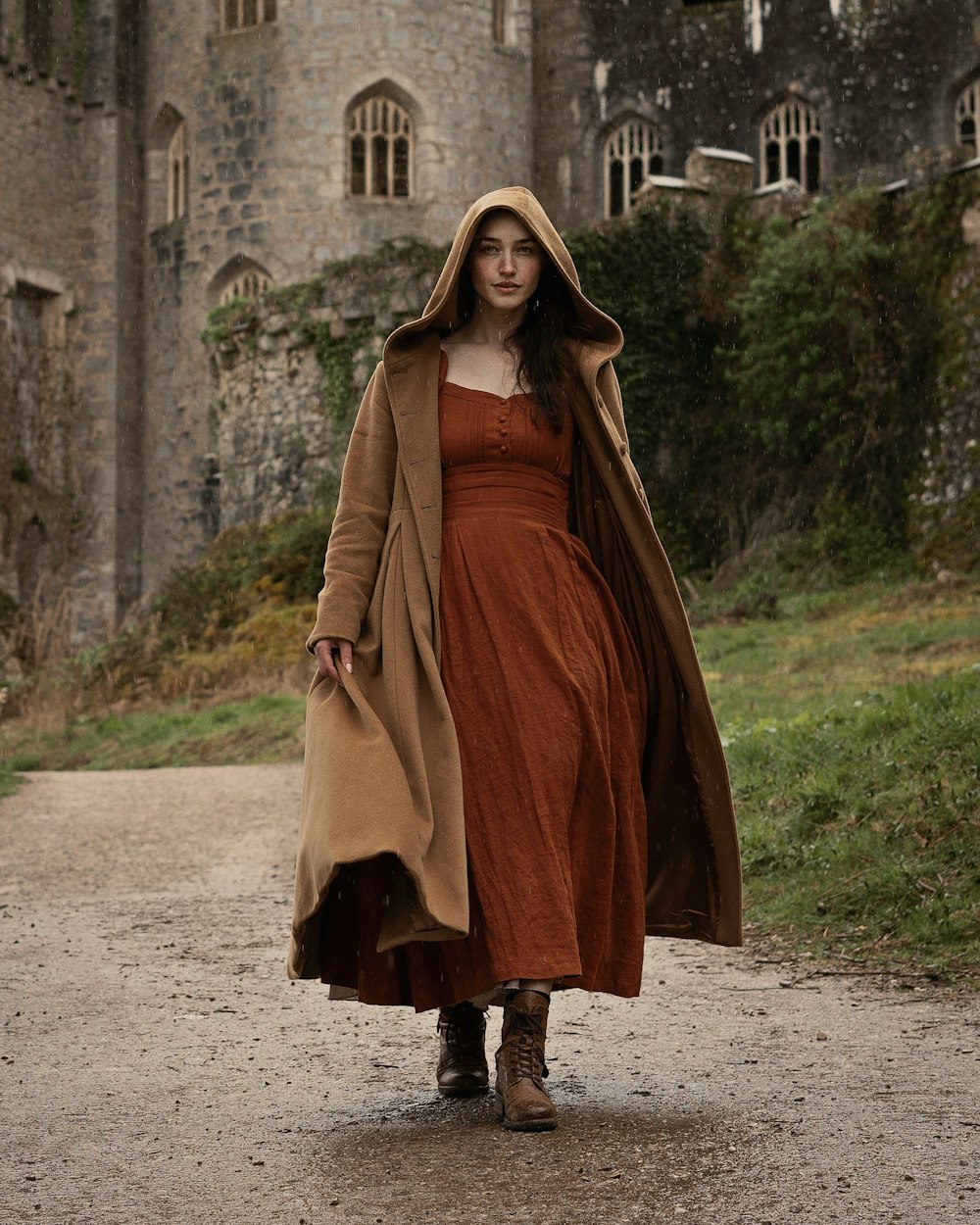a woman in a brown dress and a brown coat