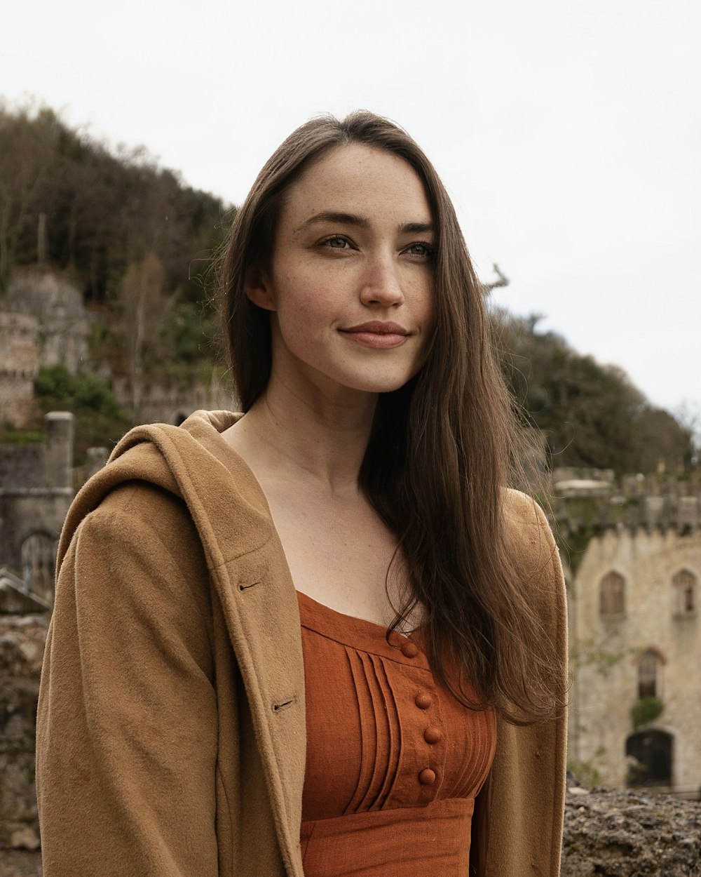 a woman standing in front of a castle