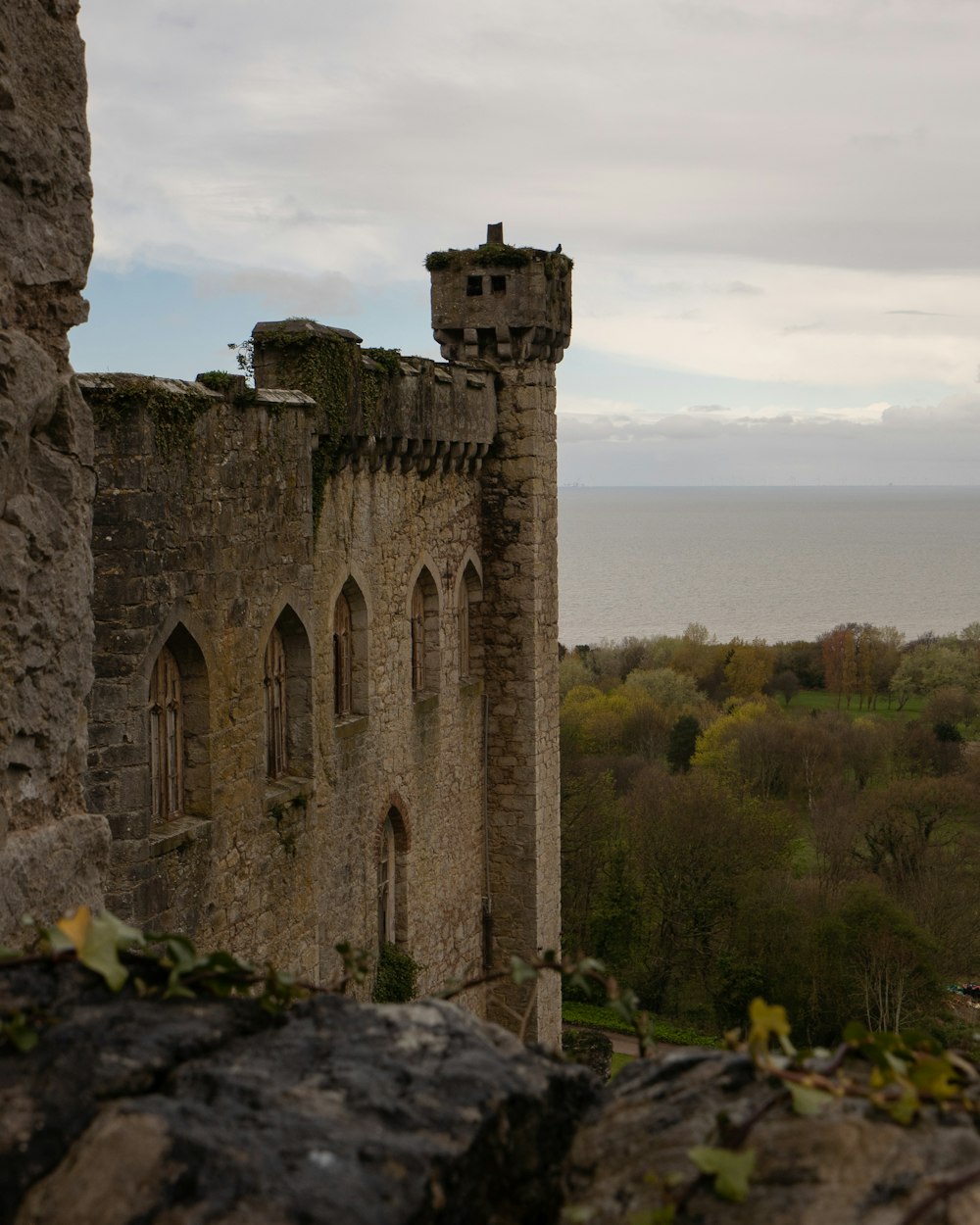 a stone castle with a view of the ocean