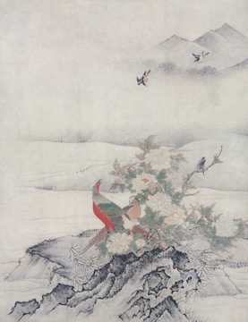 A traditional painting depicts a scene with a colorful pheasant standing on rocky terrain surrounded by blooming flowers and foliage. In the background, gentle hills fade into mist, while birds fly gracefully in the serene sky above.
