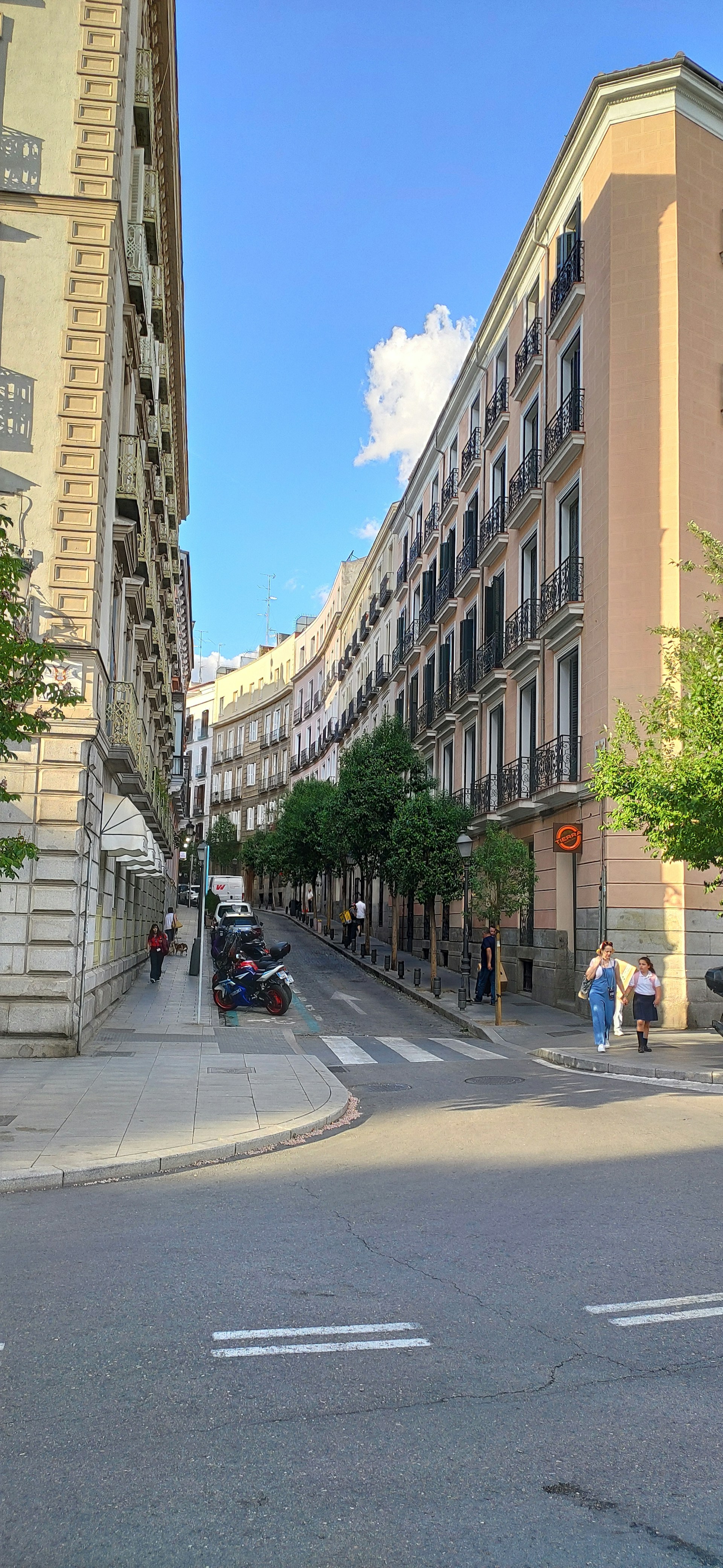 a city street with a few cars parked on the side of the road