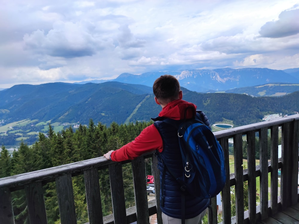 a person with a backpack standing on a balcony