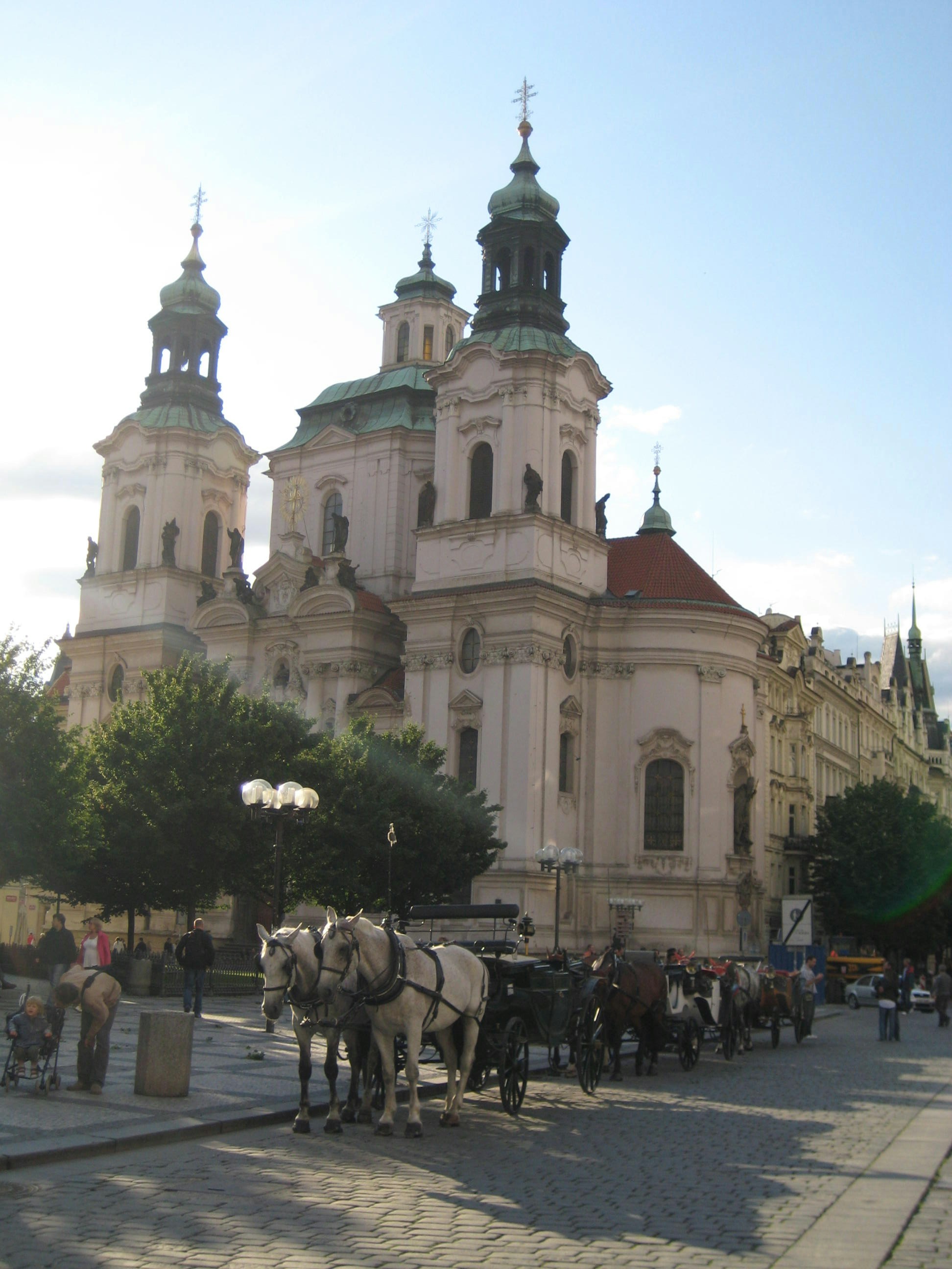 a group of horses standing in front of a building