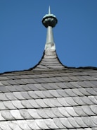 a view of the top of a building with a sky background