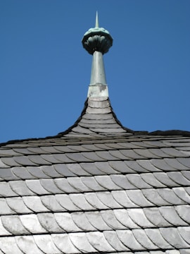 a view of the top of a building with a sky background