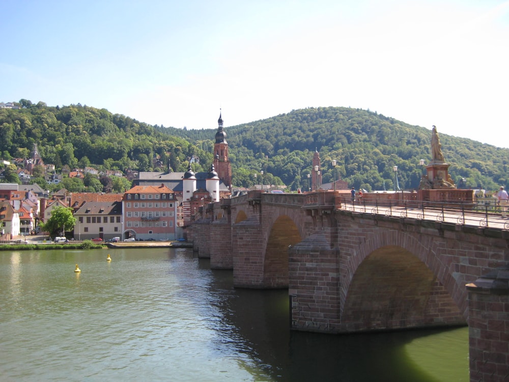 a bridge over a body of water with buildings in the background