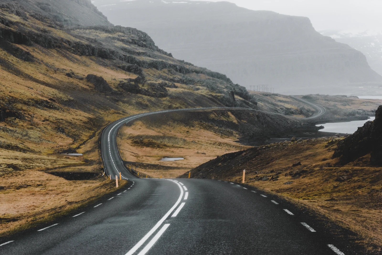 A winding road crossing Icelandic mountain scenery