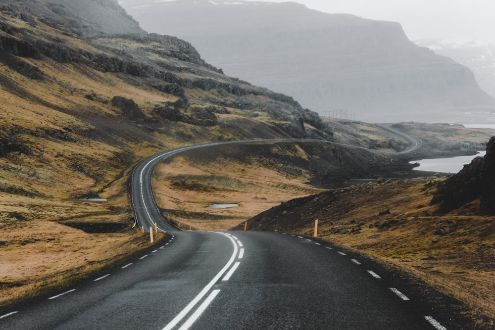 a winding road in the middle of a mountain