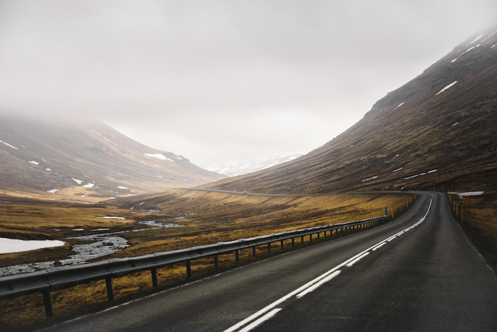 a car driving down a road in the mountains