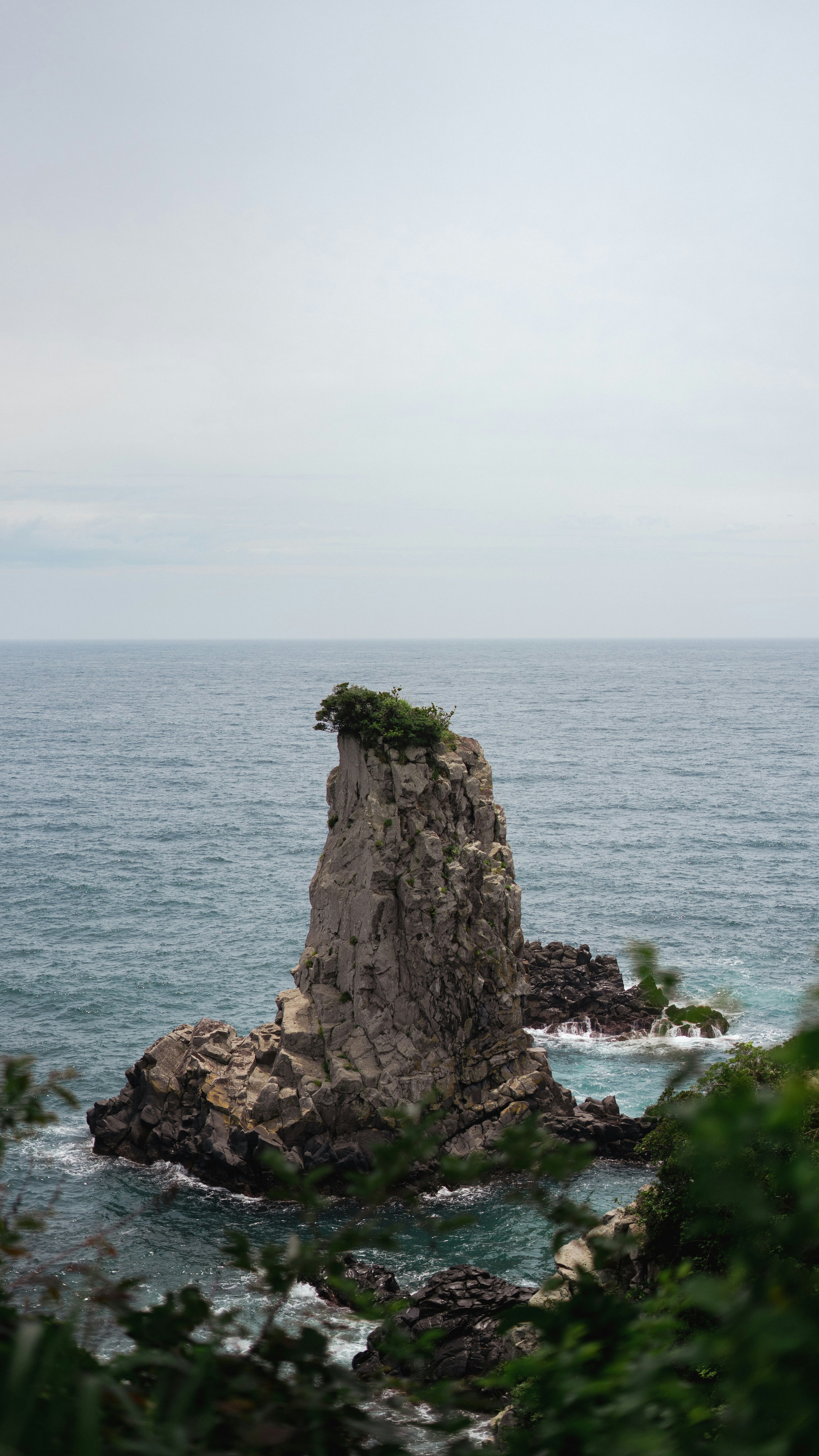a rock outcropping in the middle of the ocean