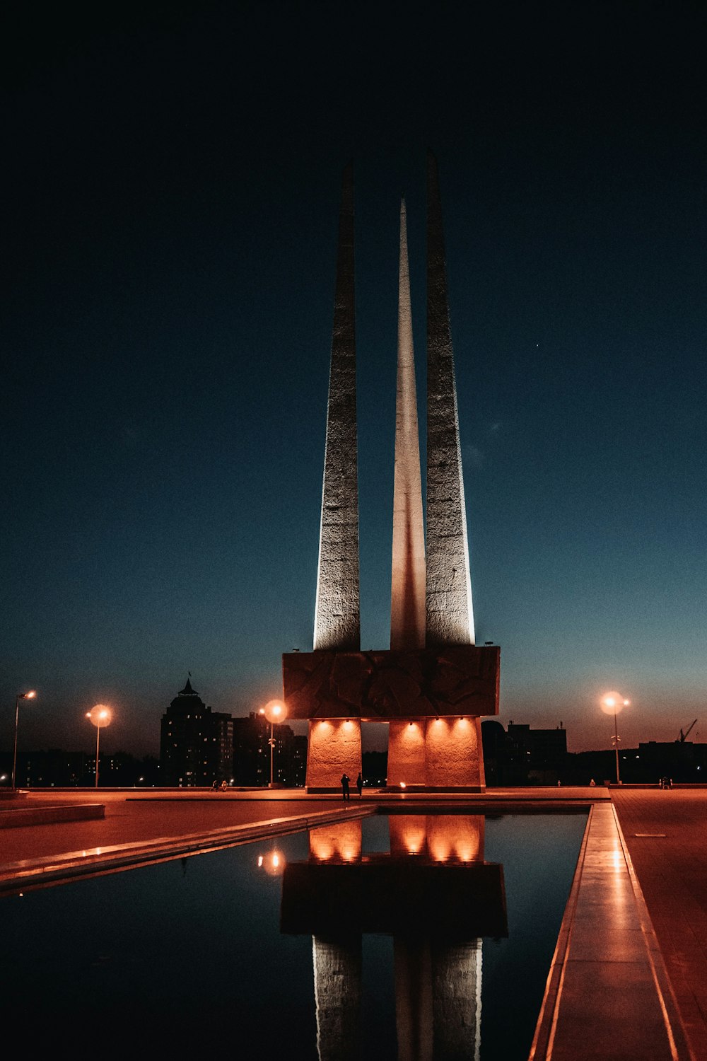 a very tall monument sitting next to a body of water