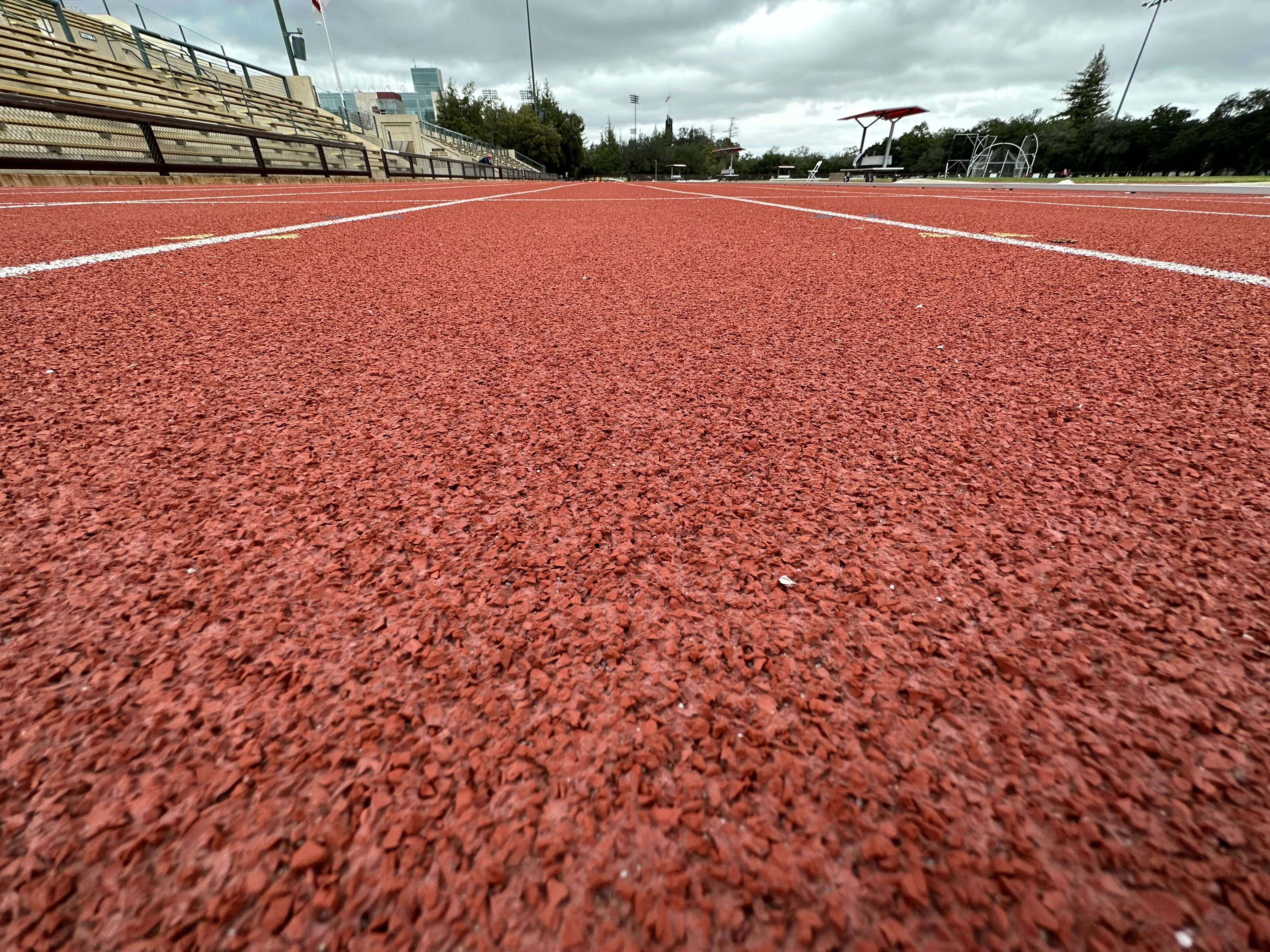 a red tennis court with white lines on it