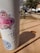 A close-up of a colorful, personalized tumbler with a creative design resting on a wooden table.