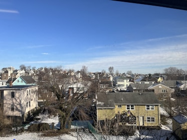 A cozy Canadian neighborhood with houses and apartments under a clear blue sky.