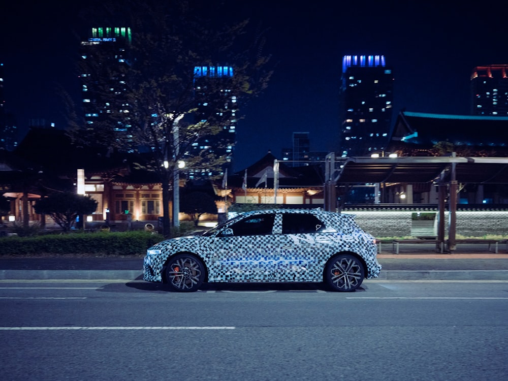 a car parked on the side of the road at night