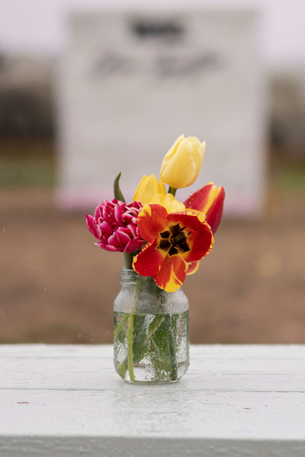 a vase filled with flowers sitting on top of a table