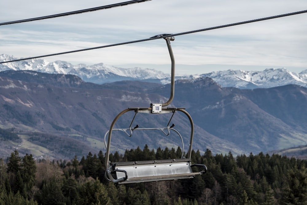 a ski lift with a view of a mountain range