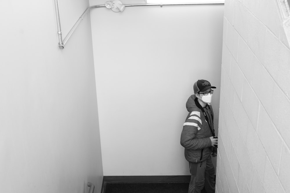 a man is standing in a narrow hallway