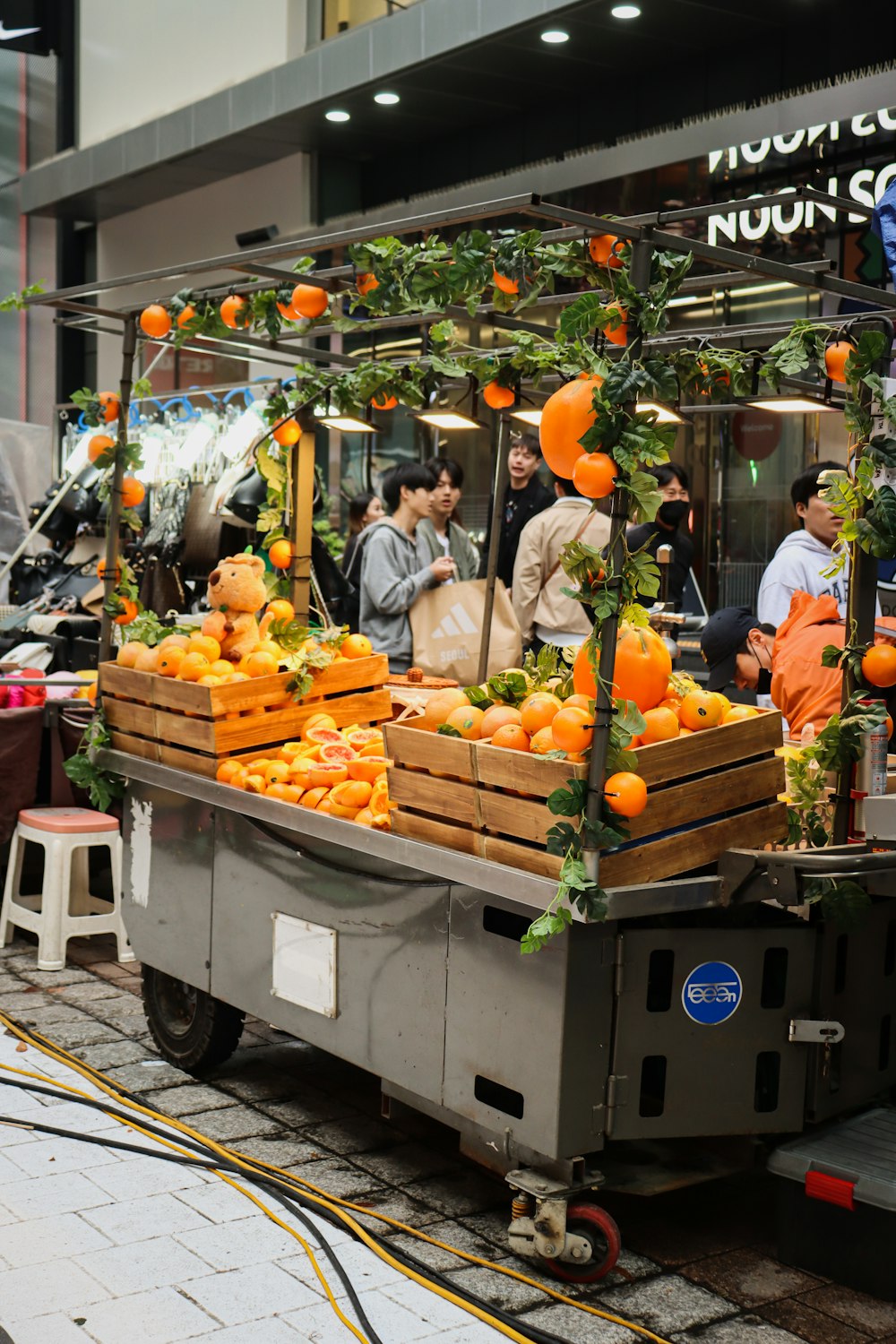 a truck filled with lots of oranges on top of a street