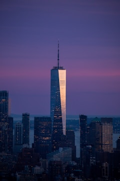 A majestic luxury skyscraper gleaming with golden highlights against a twilight sky