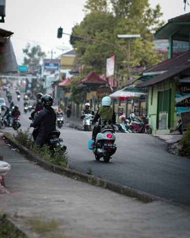 A close-up of a motorbike navigating through chaotic traffic in Thailand.