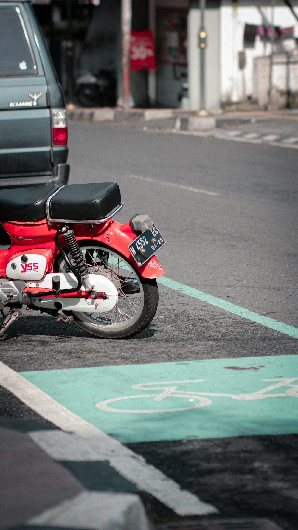 a red motorcycle parked on the side of the road