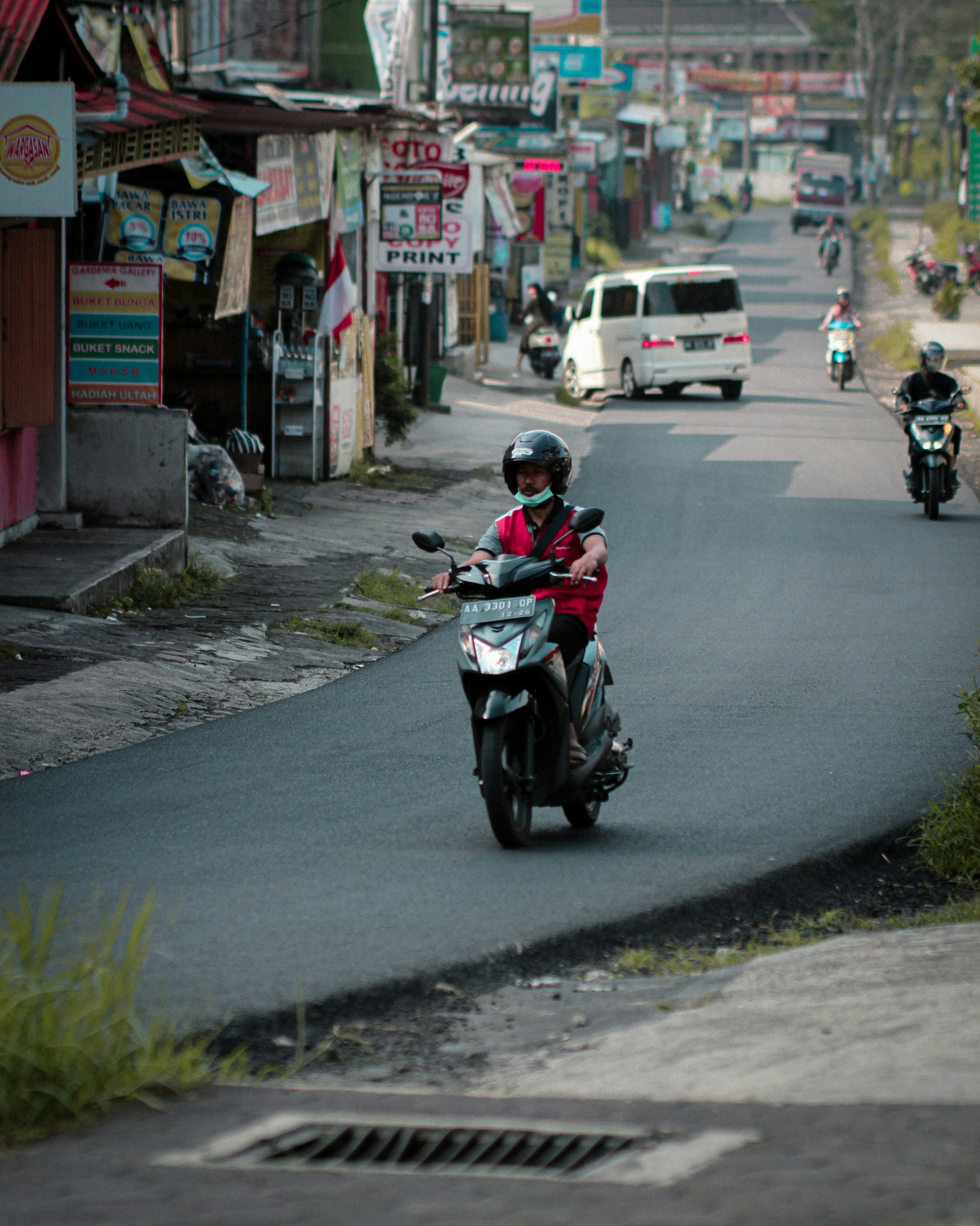 a man riding a motorcycle down a curvy street