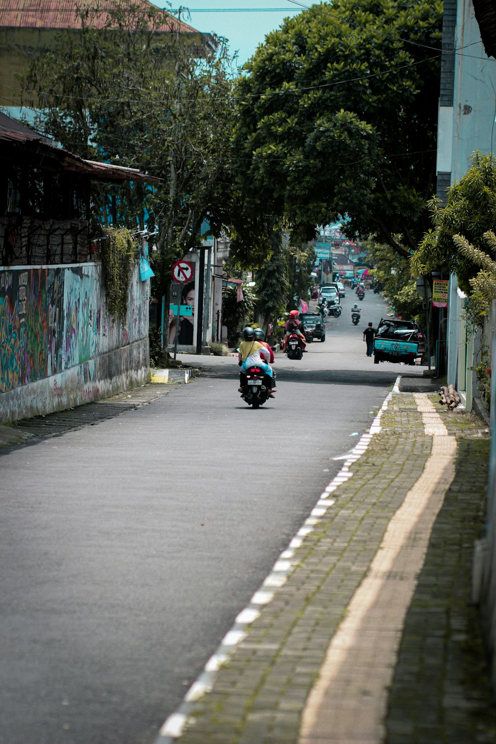 a person riding a motorcycle down a street
