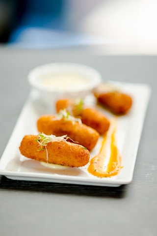 a white plate topped with fried food on top of a table