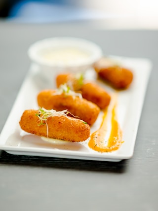 a white plate topped with fried food on top of a table