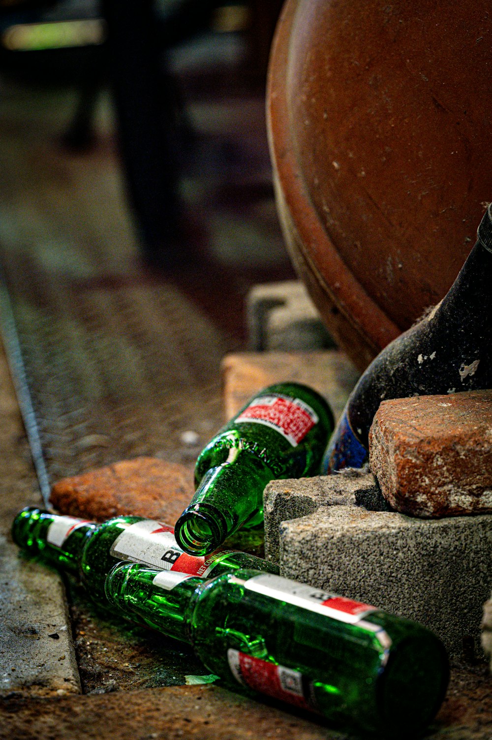 several empty beer bottles sitting on the ground