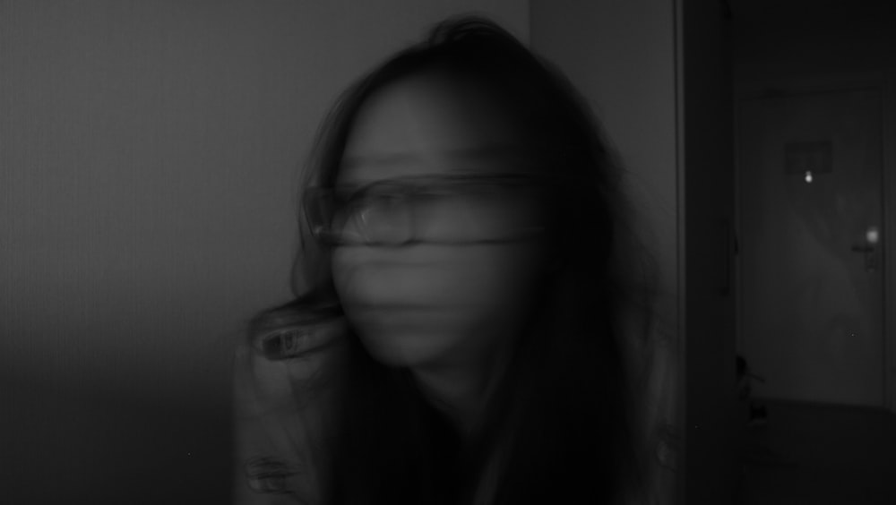 a blurry photo of a woman with glasses