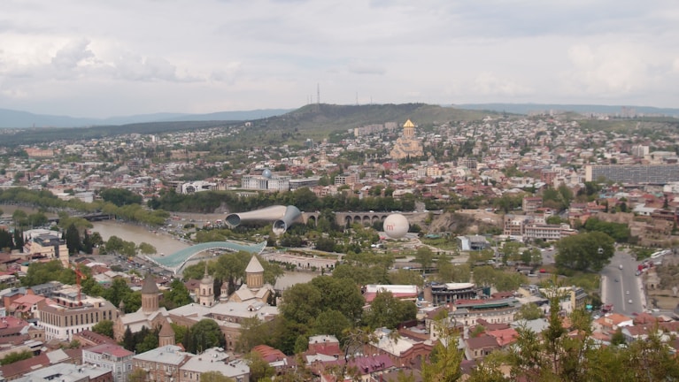 A scenic view of Tbilisi's old town with colorful buildings.