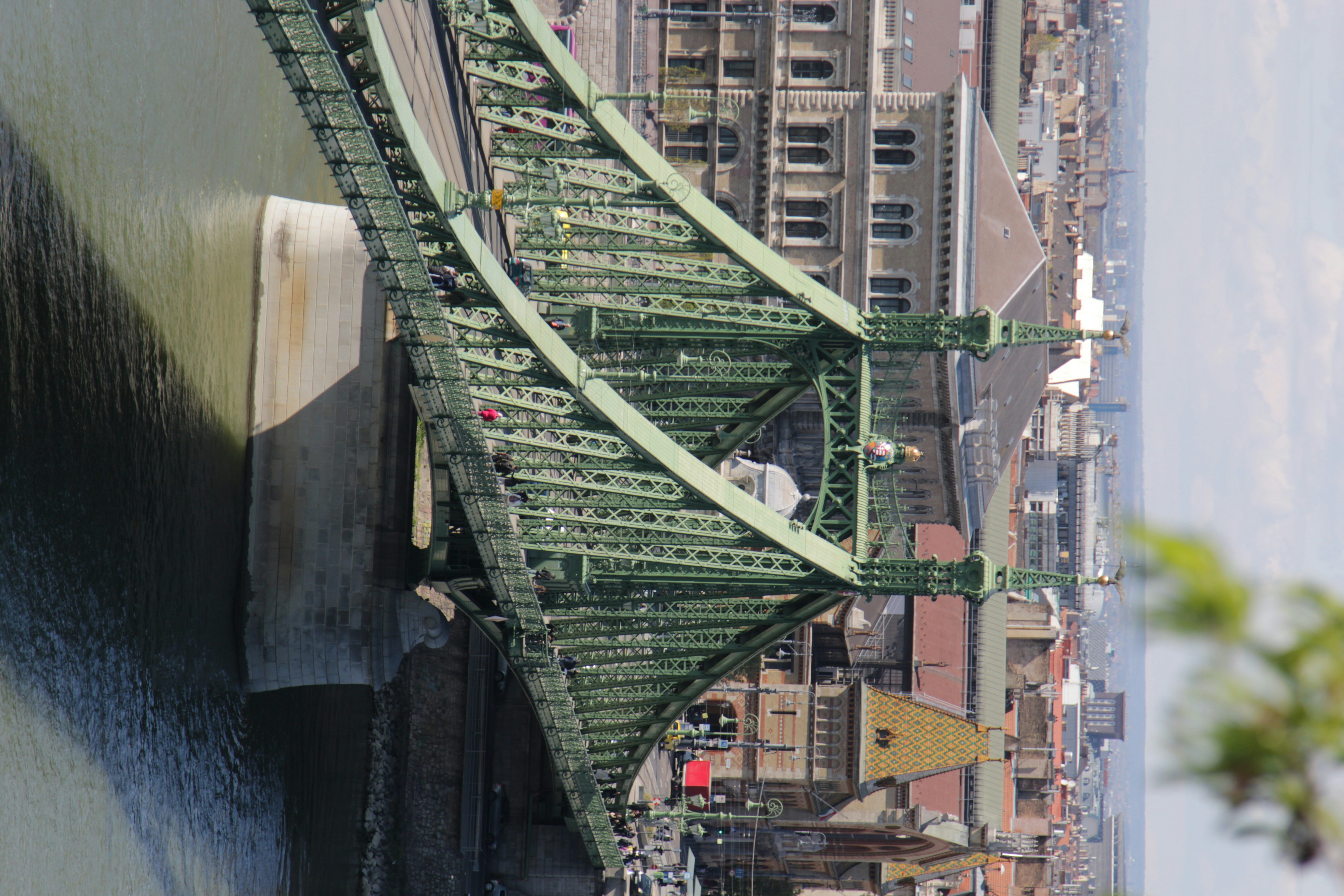 a bridge over a body of water with buildings in the background