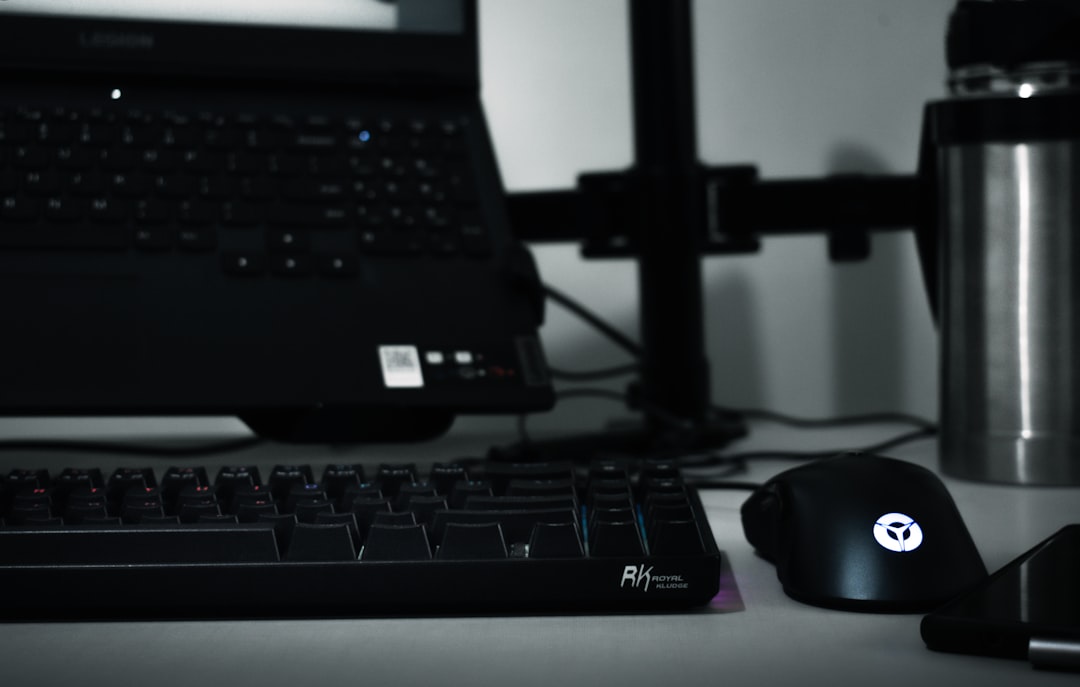 a computer keyboard, mouse, and a laptop on a desk, My old study/office desk space