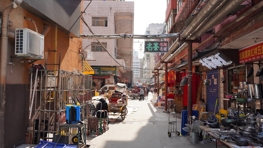 a narrow city street lined with shops and stores