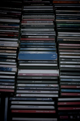 Stack of colorful DVD cases arranged neatly on a shelf.
