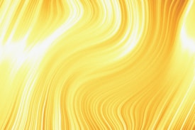 A vibrant and energetic abstract design featuring smooth, flowing lines in varying shades of bright yellow. The pattern suggests movement and dynamism with its swirling, wavy appearance.
