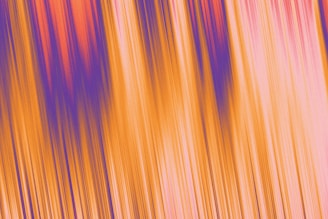 A vibrant abstract image with vertical streaks of color, including bright orange, purple, and pink, creating a sense of dynamic motion and energy.