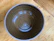 Close-up of a handmade stoneware bowl with earthy tones and subtle glaze.