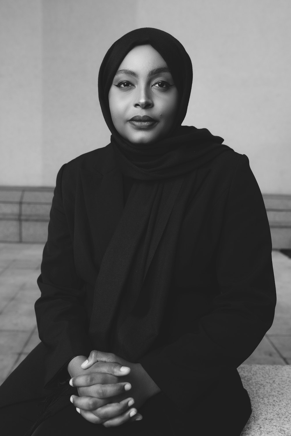 a black and white photo of a woman in a hijab