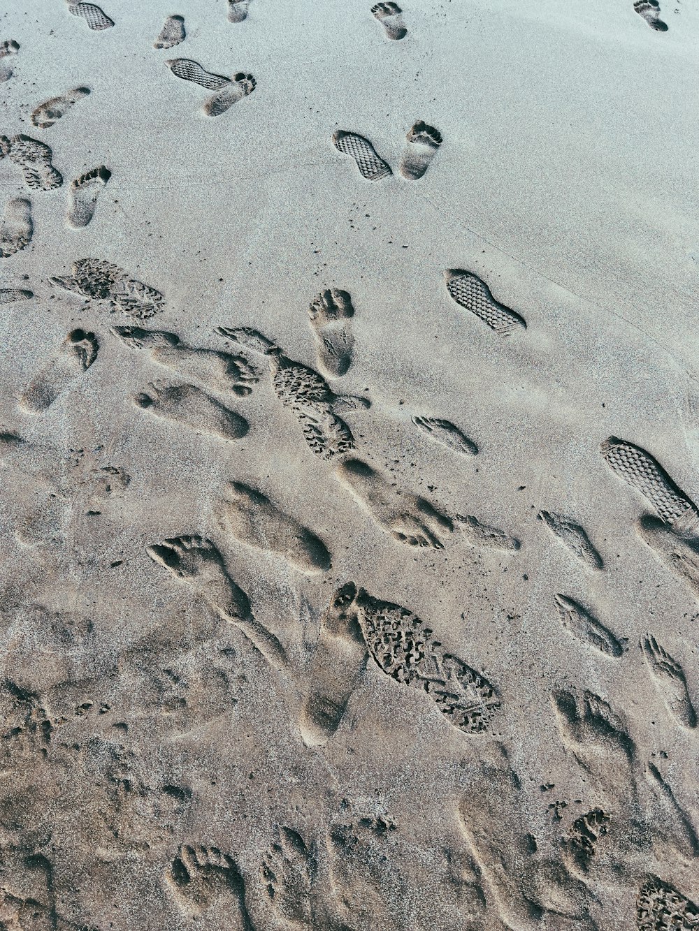 footprints in the sand of a beach near the ocean