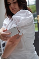 a person scanning blood glucose with a flash glucose monitor